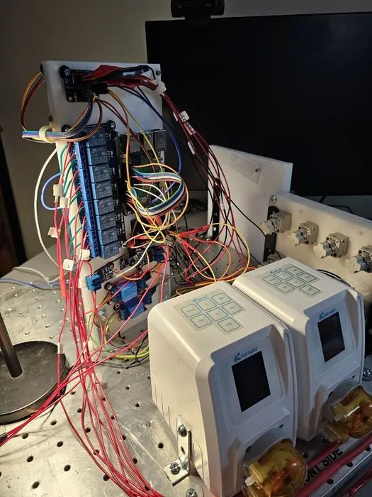 Close view of the eight-channel relay module with the coloured signal harness fanning out to the pinch valves.