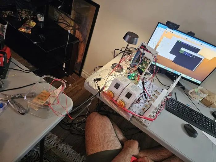 The payload prototype on a workbench with the operator laptop alongside, during a pump control test.