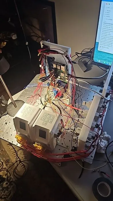 The assembled prototype running on the bench, with control software open on the laptop behind it.