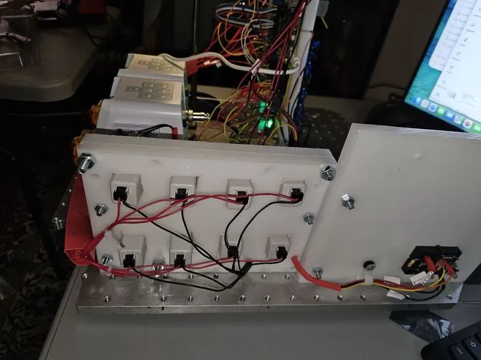 The HDPE control plate swung open, exposing the wiring harness routed behind the relay module.