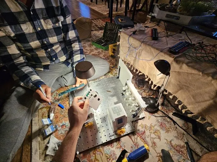 Hands positioning components on the baseplate during a fit check.