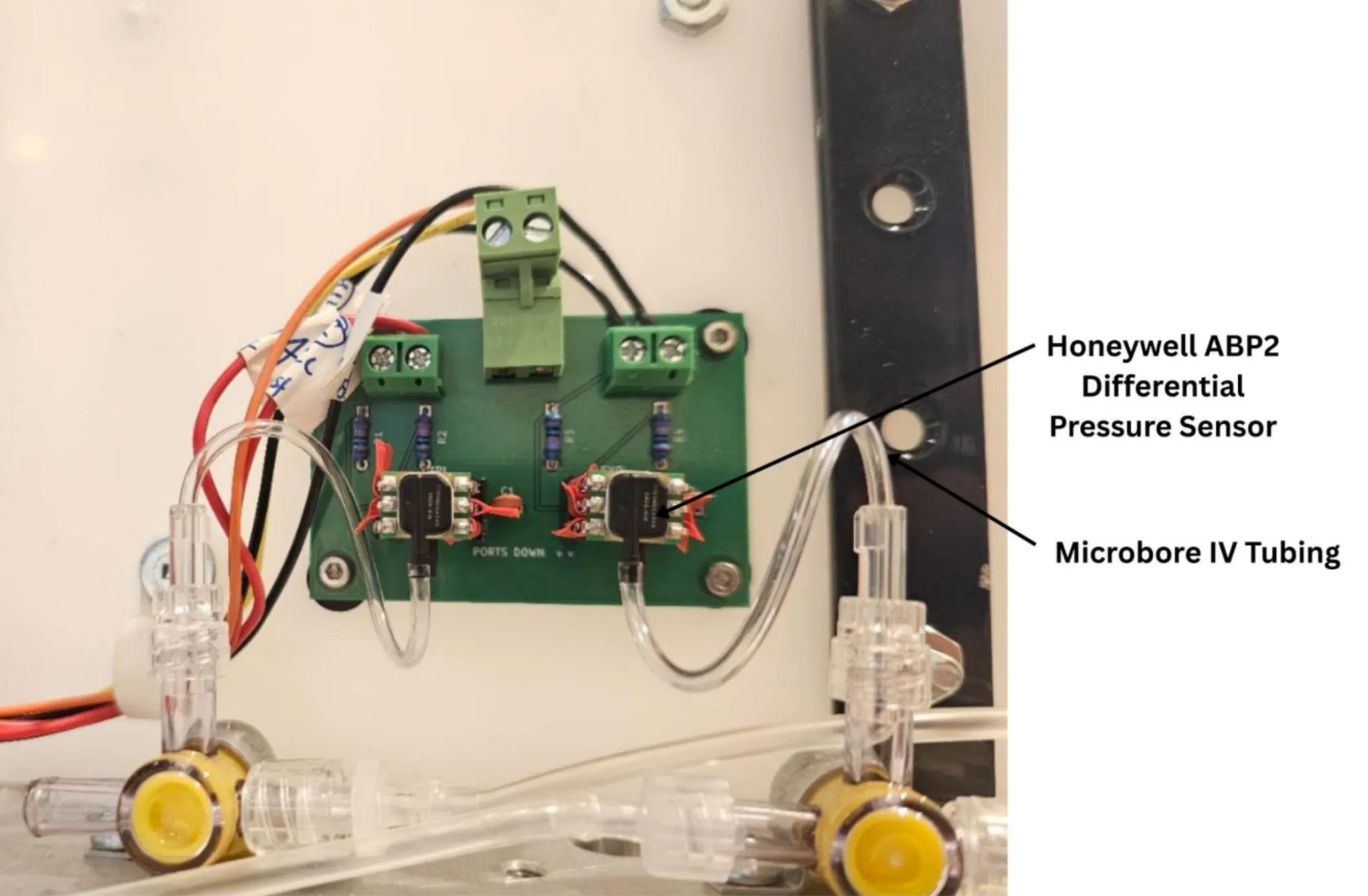 Annotated photograph identifying Honeywell ABP2 differential pressure sensors and microbore IV tubing.